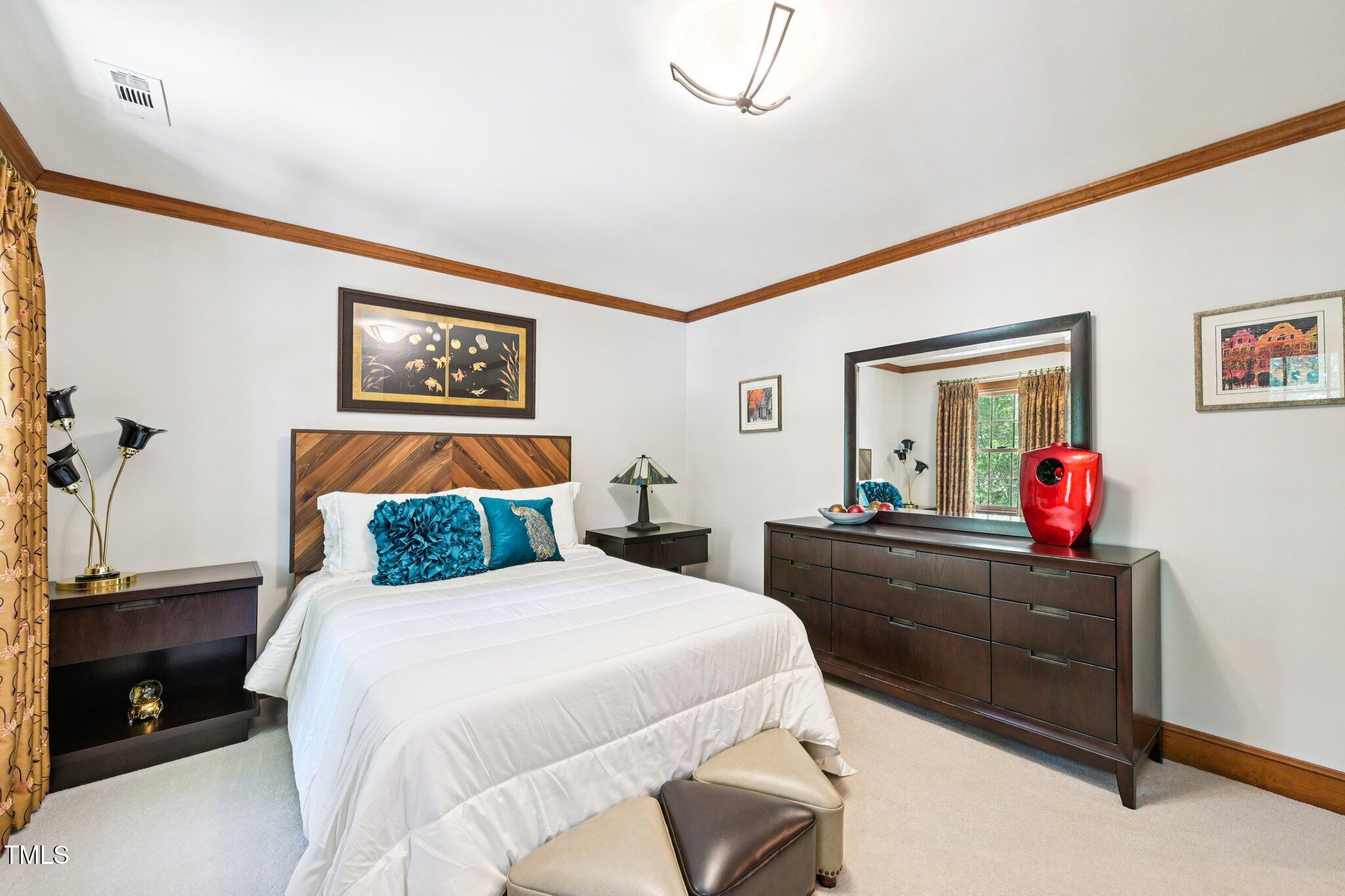 3413 1st Place Raleigh, NC 27613 - Photo 34 of 43 a bedroom with a bed and a dresser