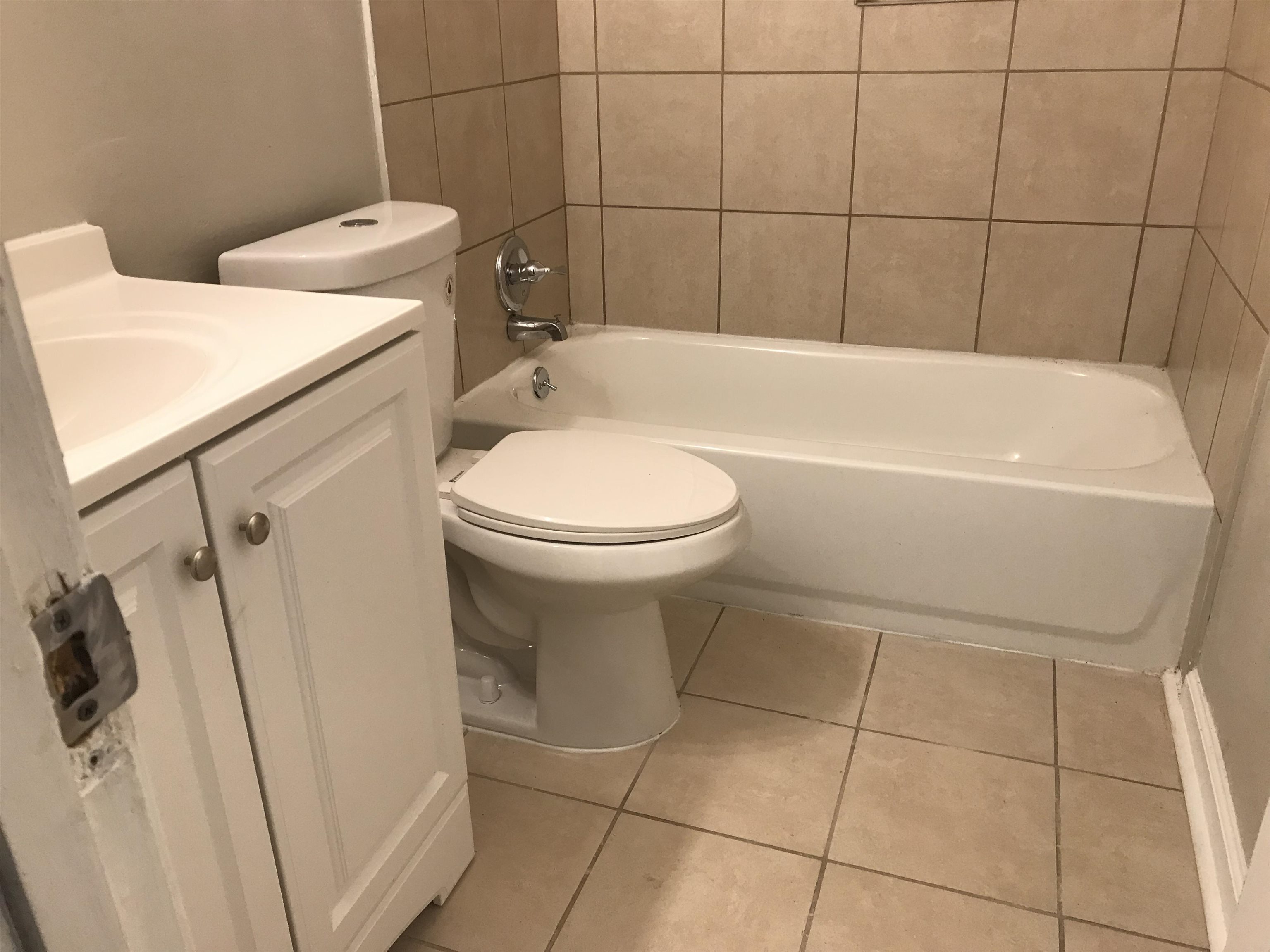 48 South Bristol Road Marion, AR 72364 - Photo 12 of 18 Bathroom featuring light tile patterned floors, vanity, and shower combination