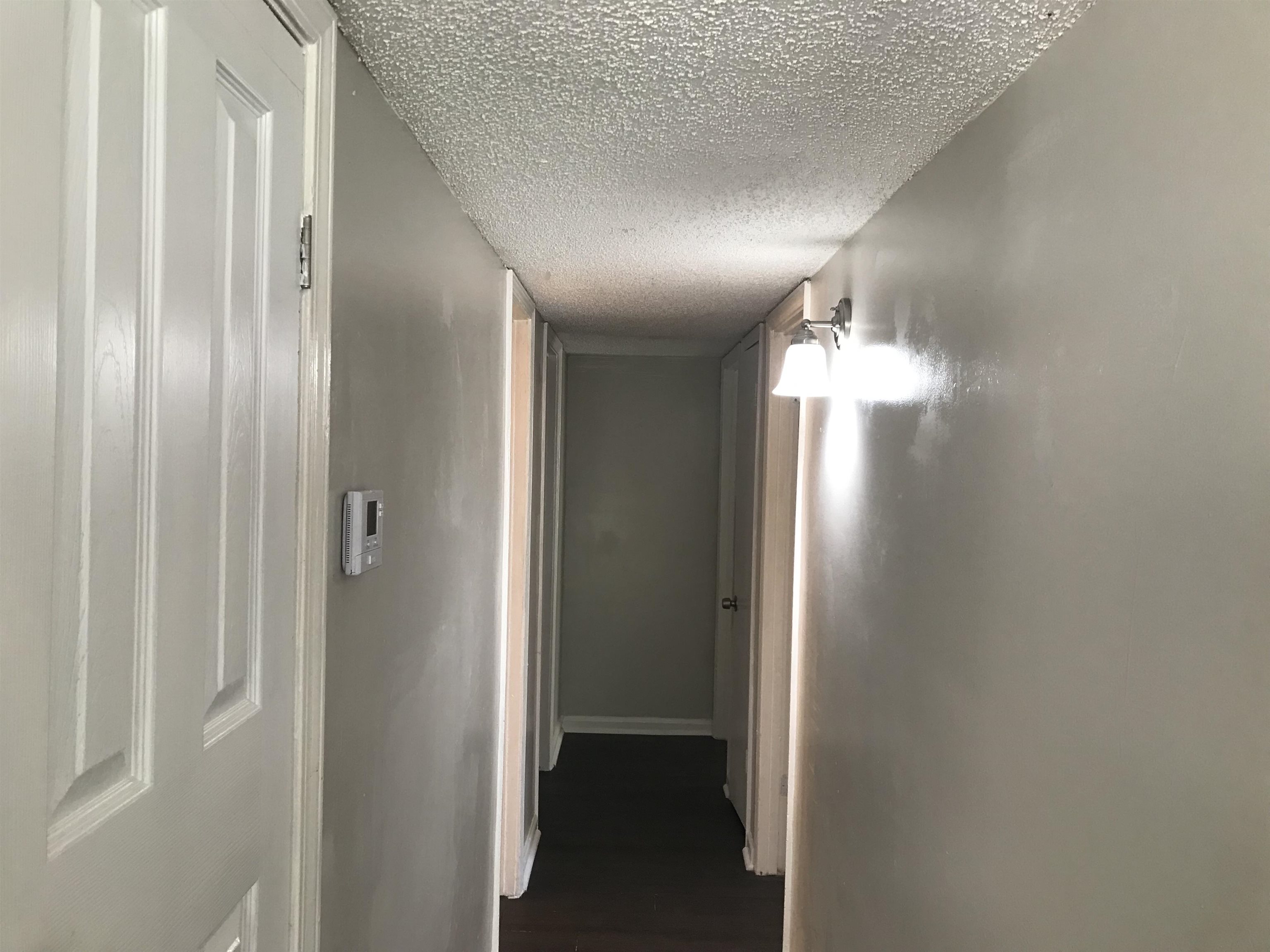 48 South Bristol Road Marion, AR 72364 - Photo 4 of 18 Corridor featuring a textured ceiling and dark wood-type flooring