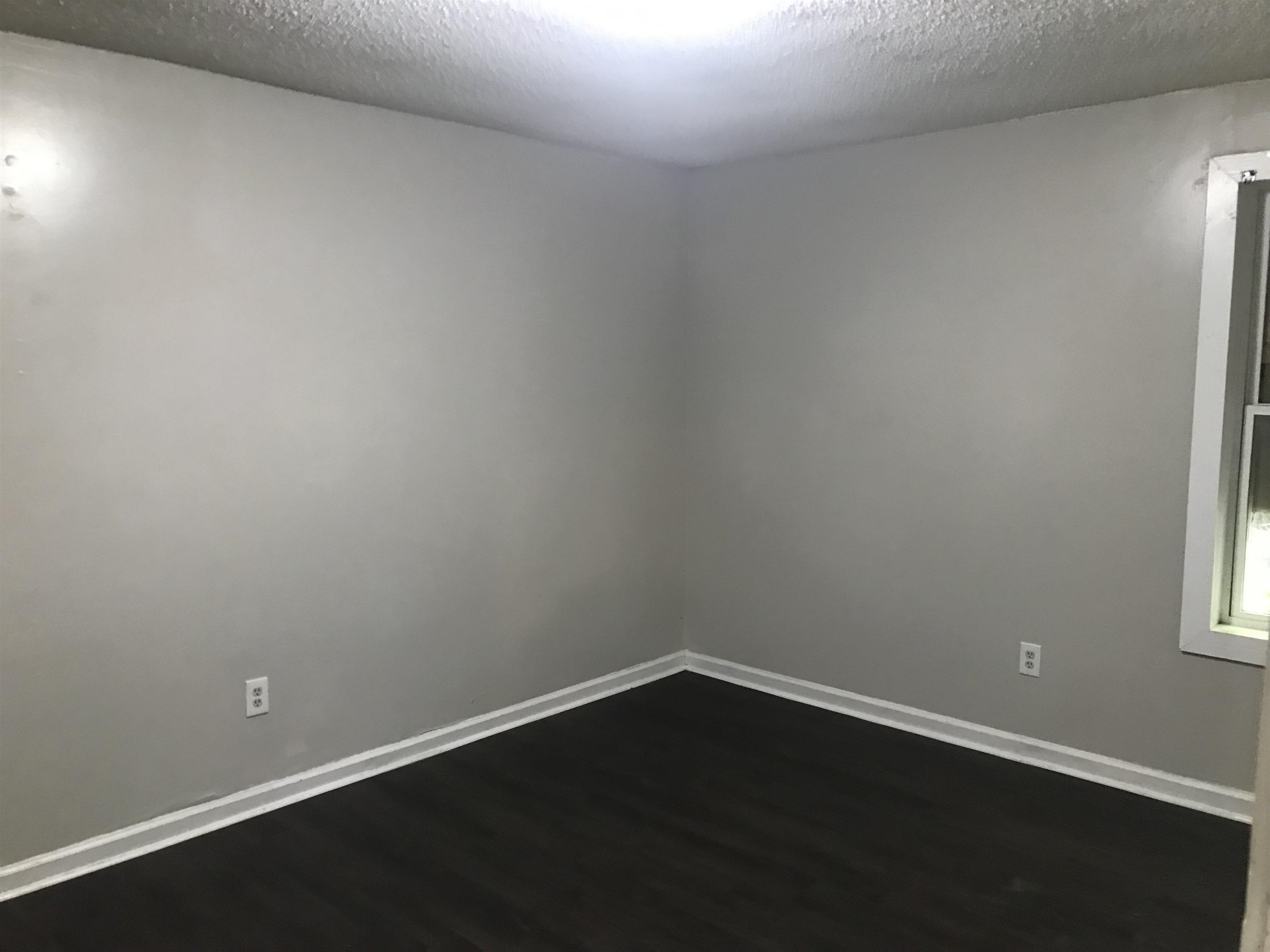 48 South Bristol Road Marion, AR 72364 - Photo 5 of 18 Empty room featuring dark wood finished floors and a textured ceiling