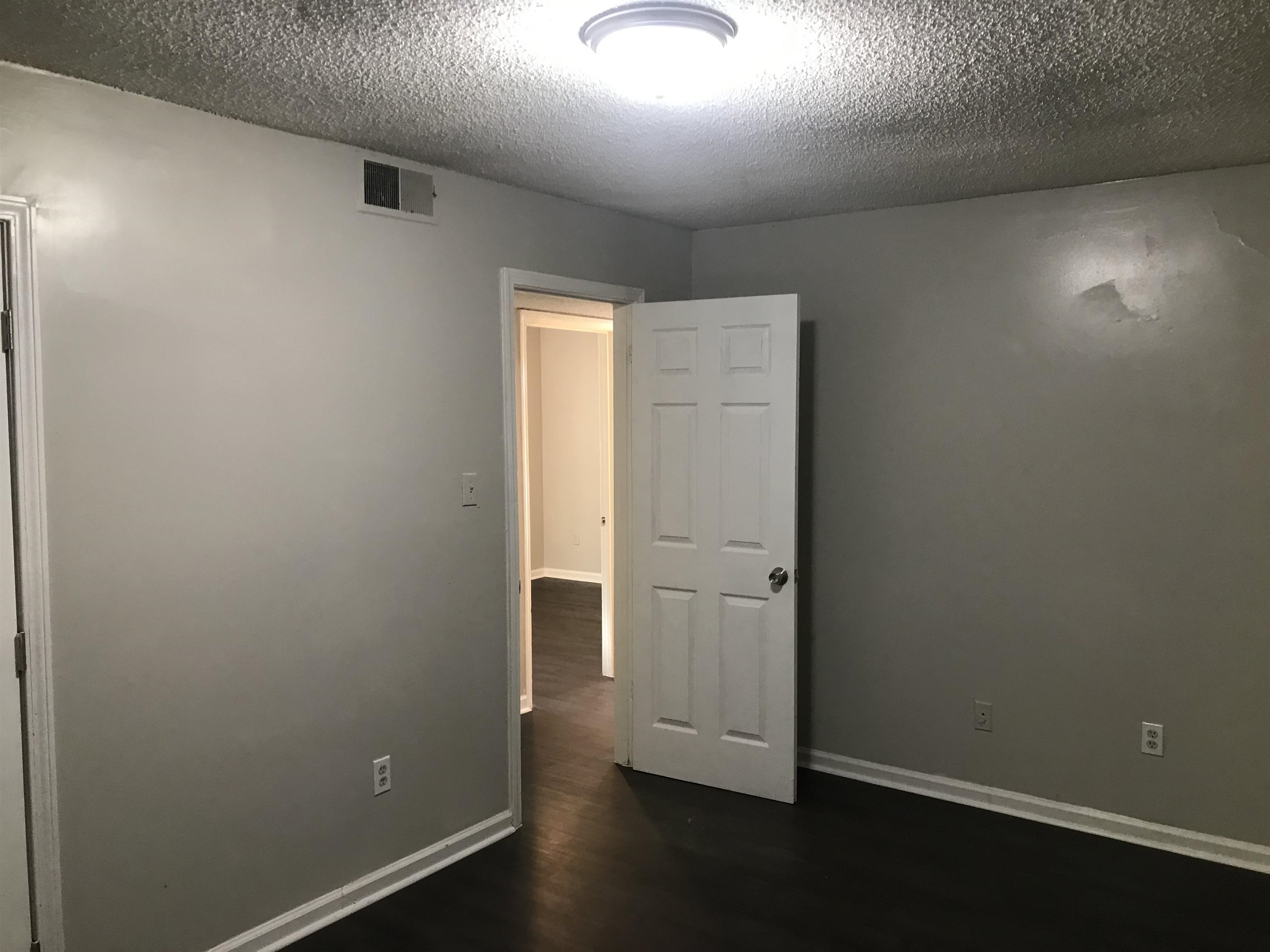 48 South Bristol Road Marion, AR 72364 - Photo 6 of 18 Spare room with dark wood-style floors and a textured ceiling