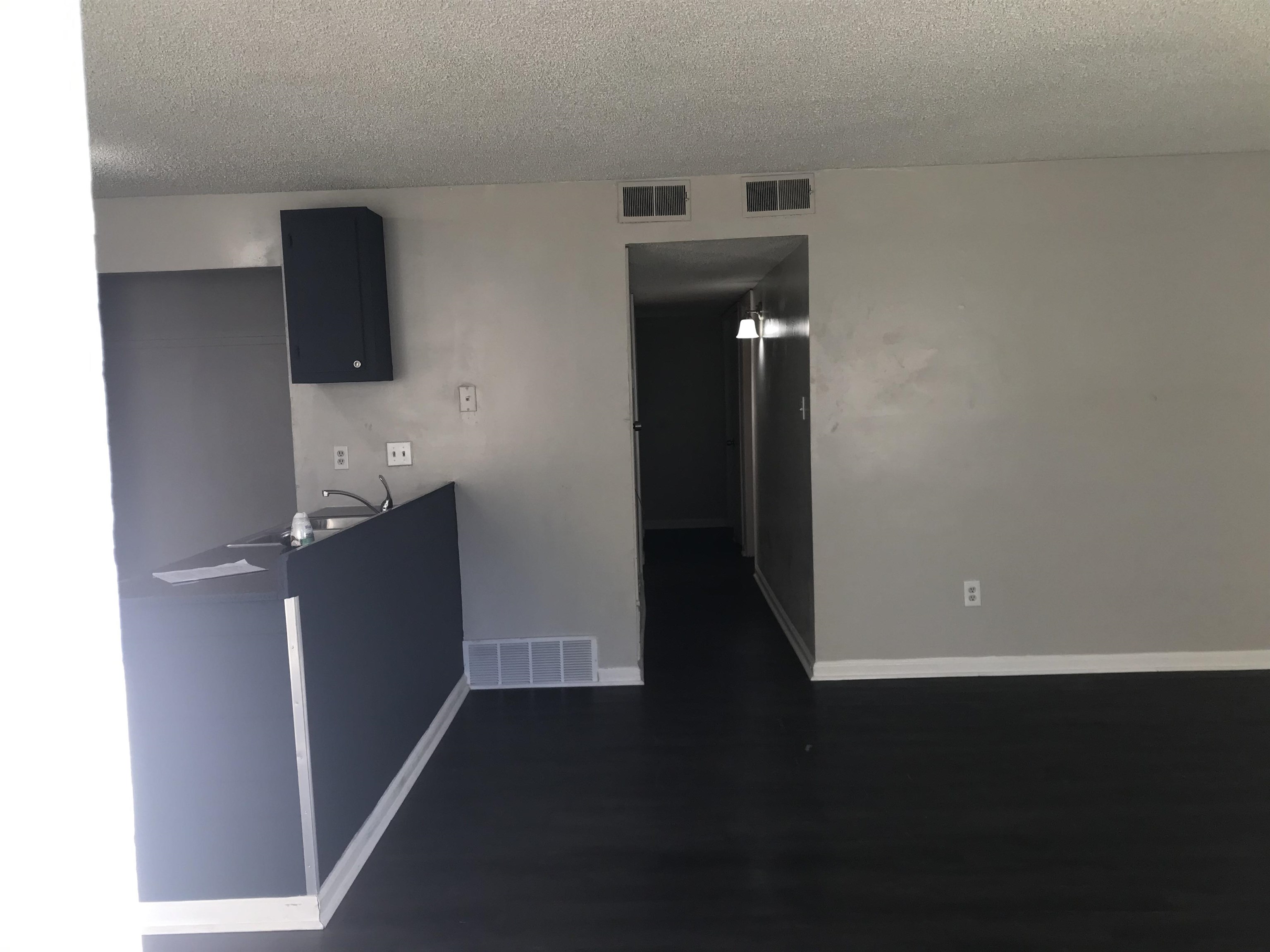 48 South Bristol Road Marion, AR 72364 - Photo 9 of 18 Kitchen with a textured ceiling, a peninsula, dark wood-type flooring, and dark countertops