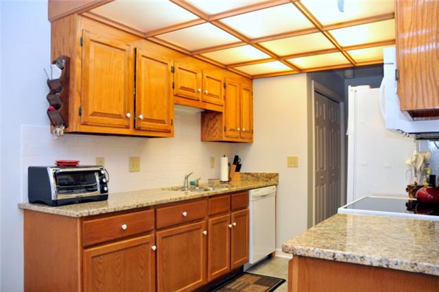 1301 General George Patton Road Nashville, TN 37221 - Photo 5 of 10 a kitchen with stainless steel appliances granite countertop a sink and cabinets