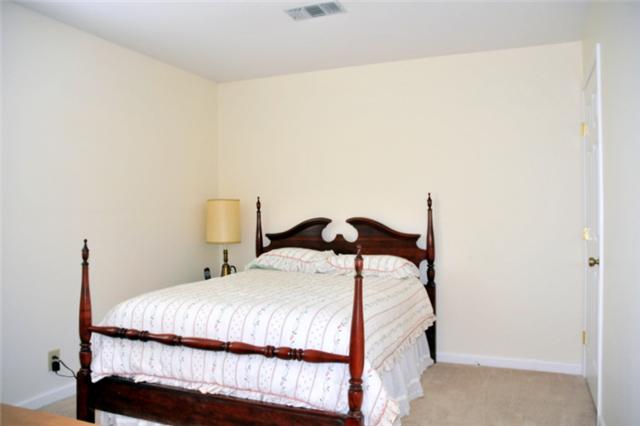 1301 General George Patton Road Nashville, TN 37221 - Photo 9 of 10 a bedroom with a bed and a table