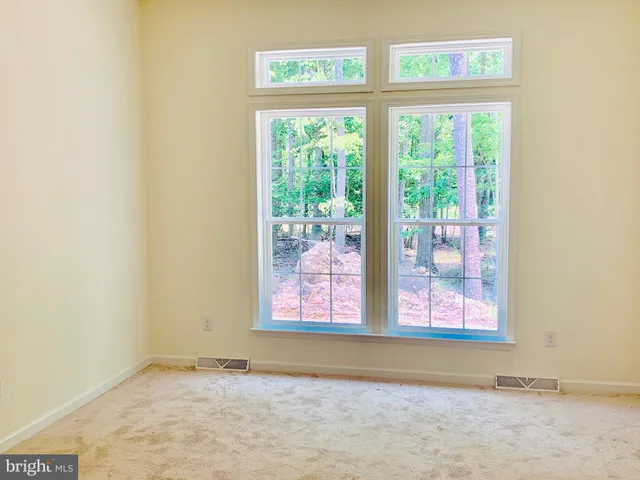 a kitchen with stainless steel appliances granite countertop a stove top oven a sink dishwasher and a refrigerator with wooden floor