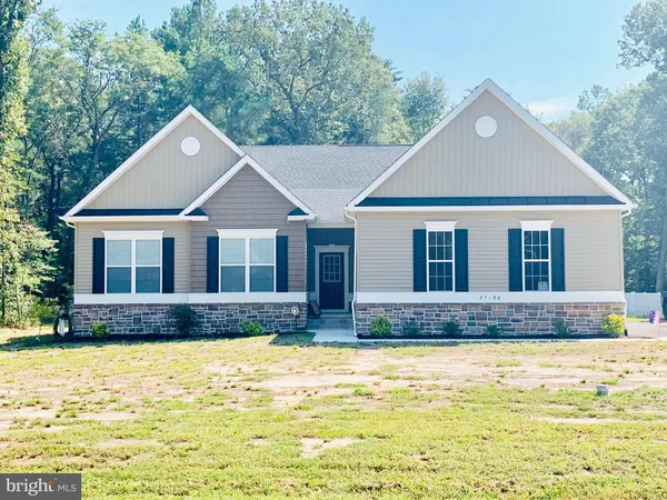 a house that has a tree in front of it
