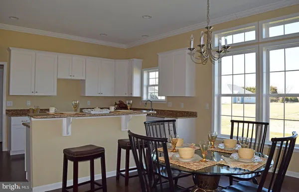 a view of a dining room with furniture and windows