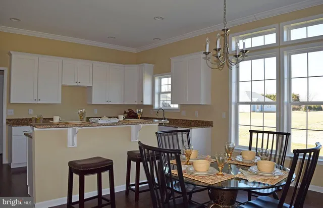 a view of a dining room with furniture and windows