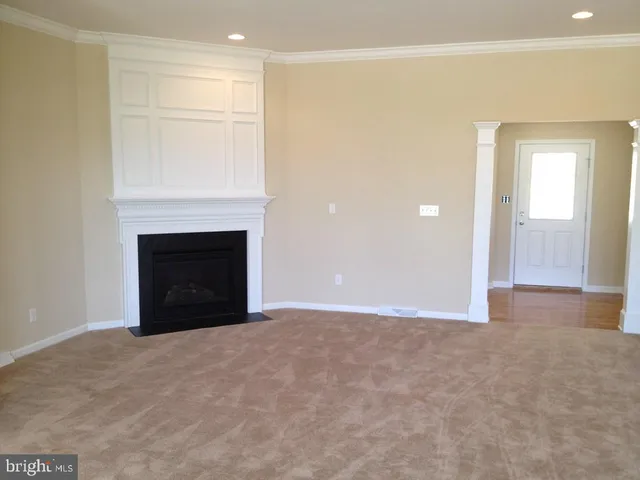 a view of an empty room with a fireplace
