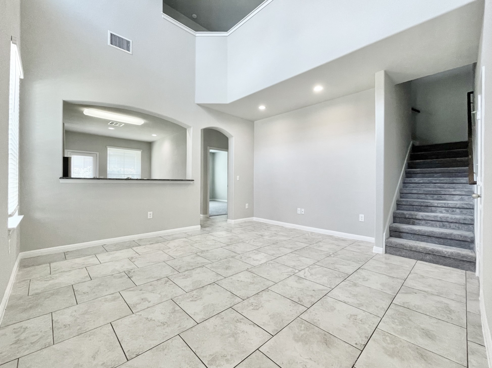 407 Rhetoric Way Pflugerville, TX 78660 - Photo 5 of 38 a view of a hallway with wooden floor and a living room