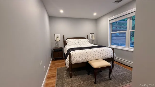 a bed sitting in a bedroom next to a window