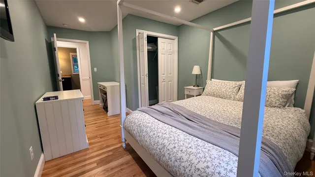 a bedroom with a bed and a mirror