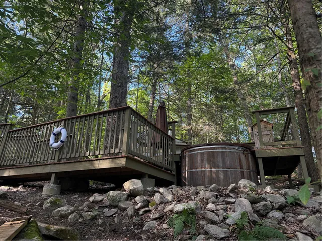 a balcony with wooden fence and trees