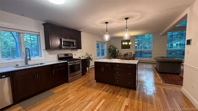 a kitchen with a sink stove and microwave