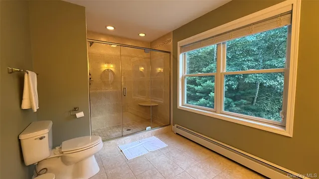 a bathroom with a granite countertop toilet a sink and a shower