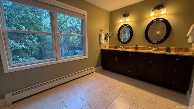 a living room with a mirror and a large window