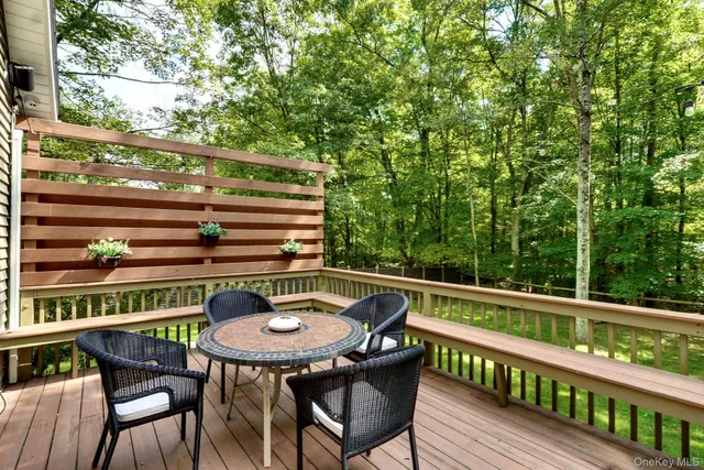 a view of a chairs and table in the balcony