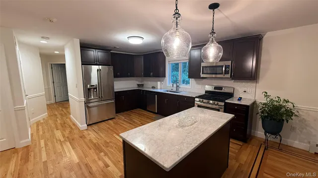 a kitchen with refrigerator and microwave