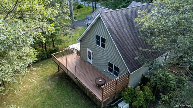a view of a couches in the deck under a large tree