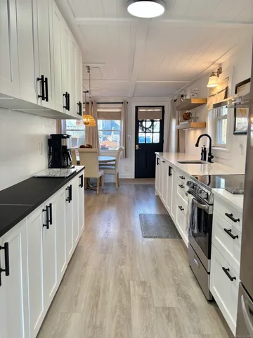 a view of a patio with table and chairs and wooden floor
