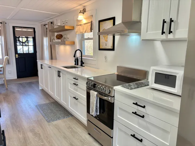 a view of a patio with table and chairs potted plants