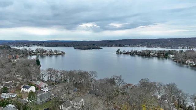 a kitchen with stainless steel appliances a refrigerator a stove top oven a dining table and chairs