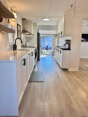 a living room with furniture and kitchen view