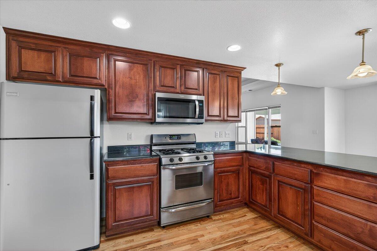 2618 Rabun Way Central Point, OR 97502 - Photo 14 of 42 a kitchen with stainless steel appliances granite countertop a refrigerator stove a sink dishwasher and microwave