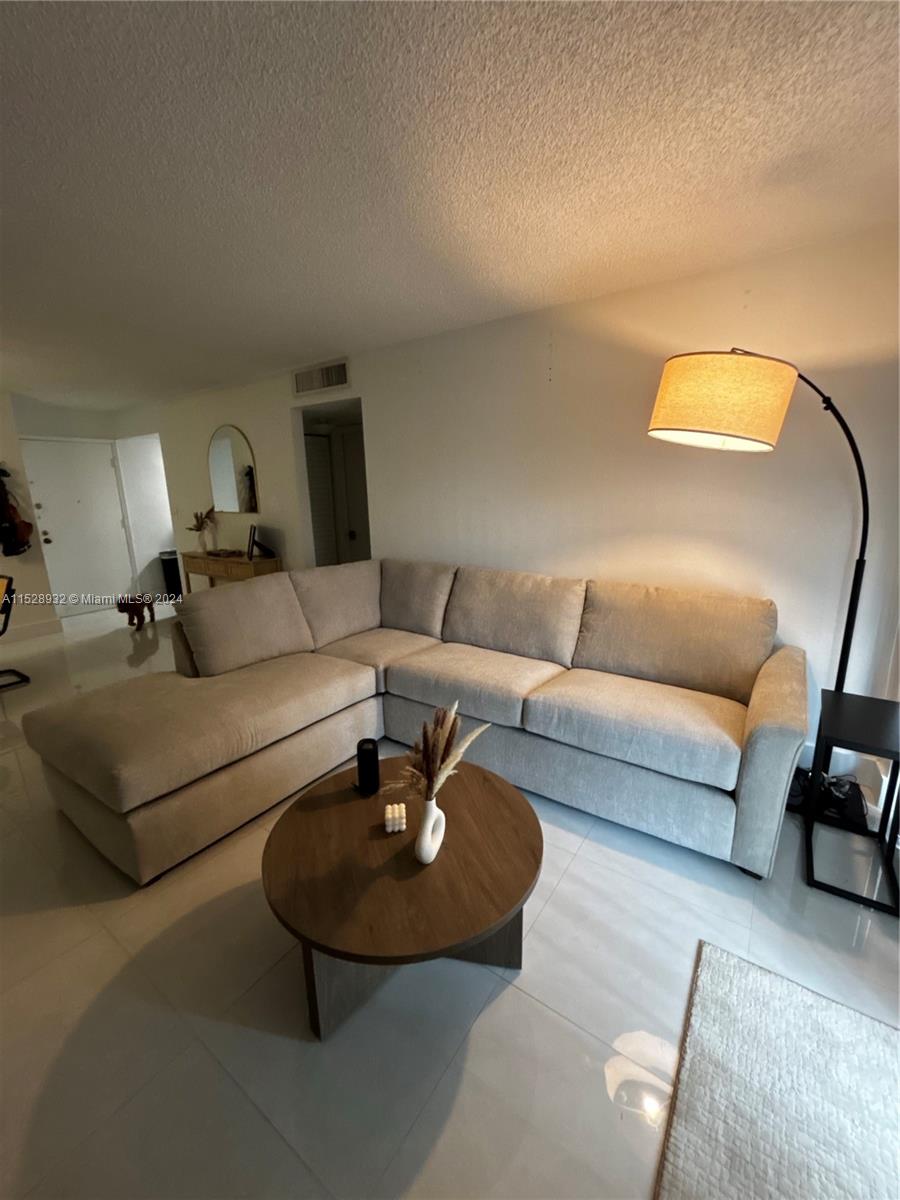 a living room with furniture and a lamp