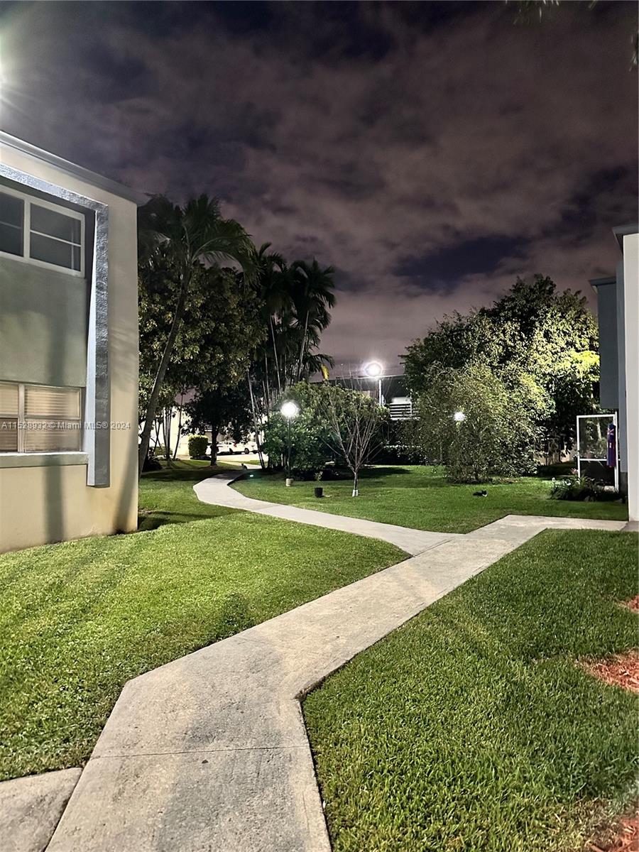 8794 Southwest 12th Street, Unit 108 Miami, FL 33174 - Photo 6 of 7 a view of a yard with plants and large trees
