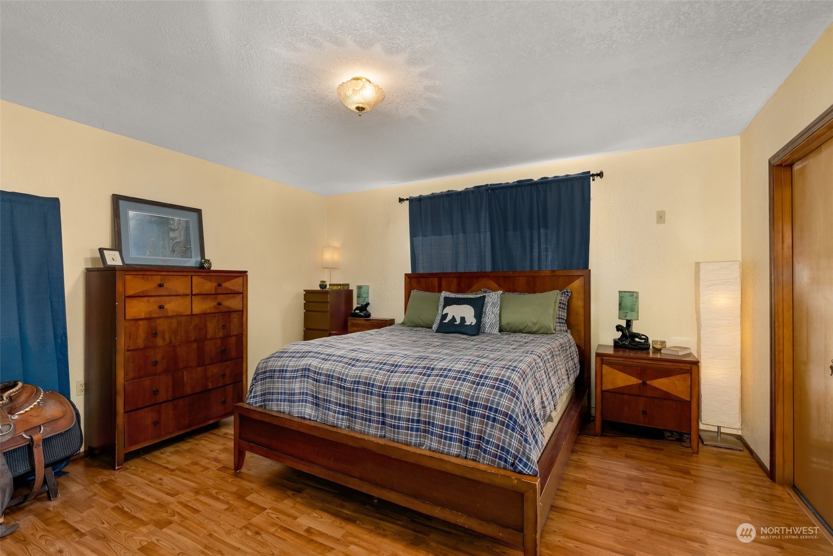 434 Cispus Road Randle, WA 98377 - Photo 14 of 40 a bedroom with a bed and wooden floor