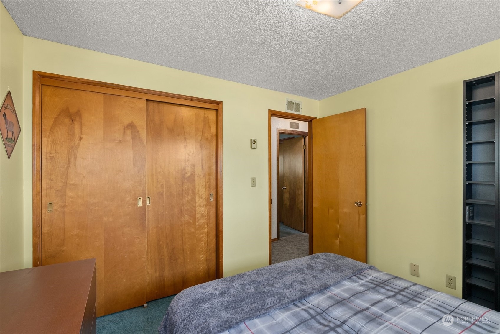 434 Cispus Road Randle, WA 98377 - Photo 19 of 40 a bedroom with a bed and wooden floor