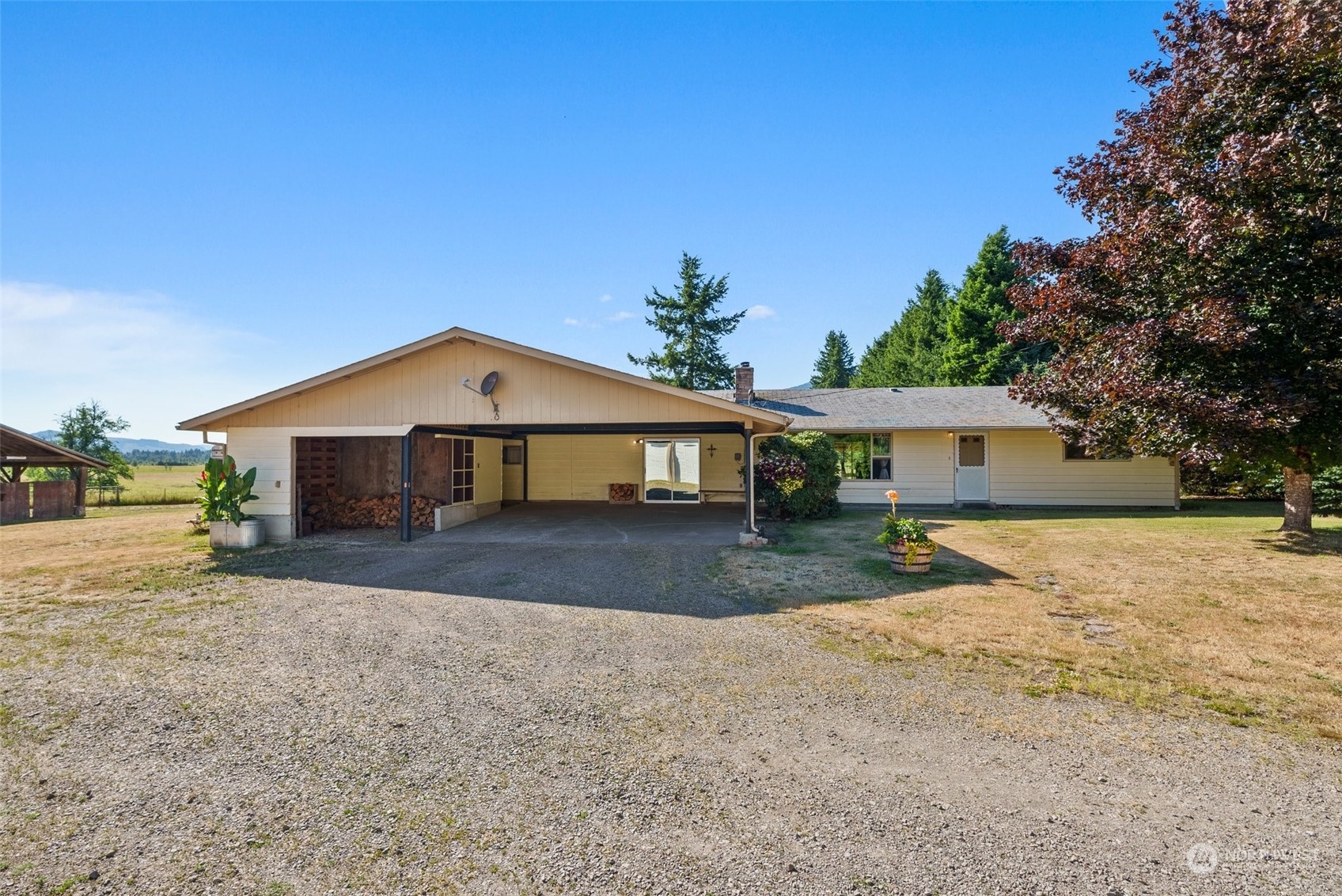 434 Cispus Road Randle, WA 98377 - Photo 2 of 40 a front view of a house with a yard and garage
