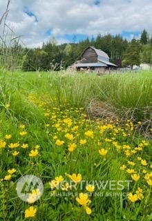 434 Cispus Road Randle, WA 98377 - Photo 34 of 40 a view of a lake with a house in the background