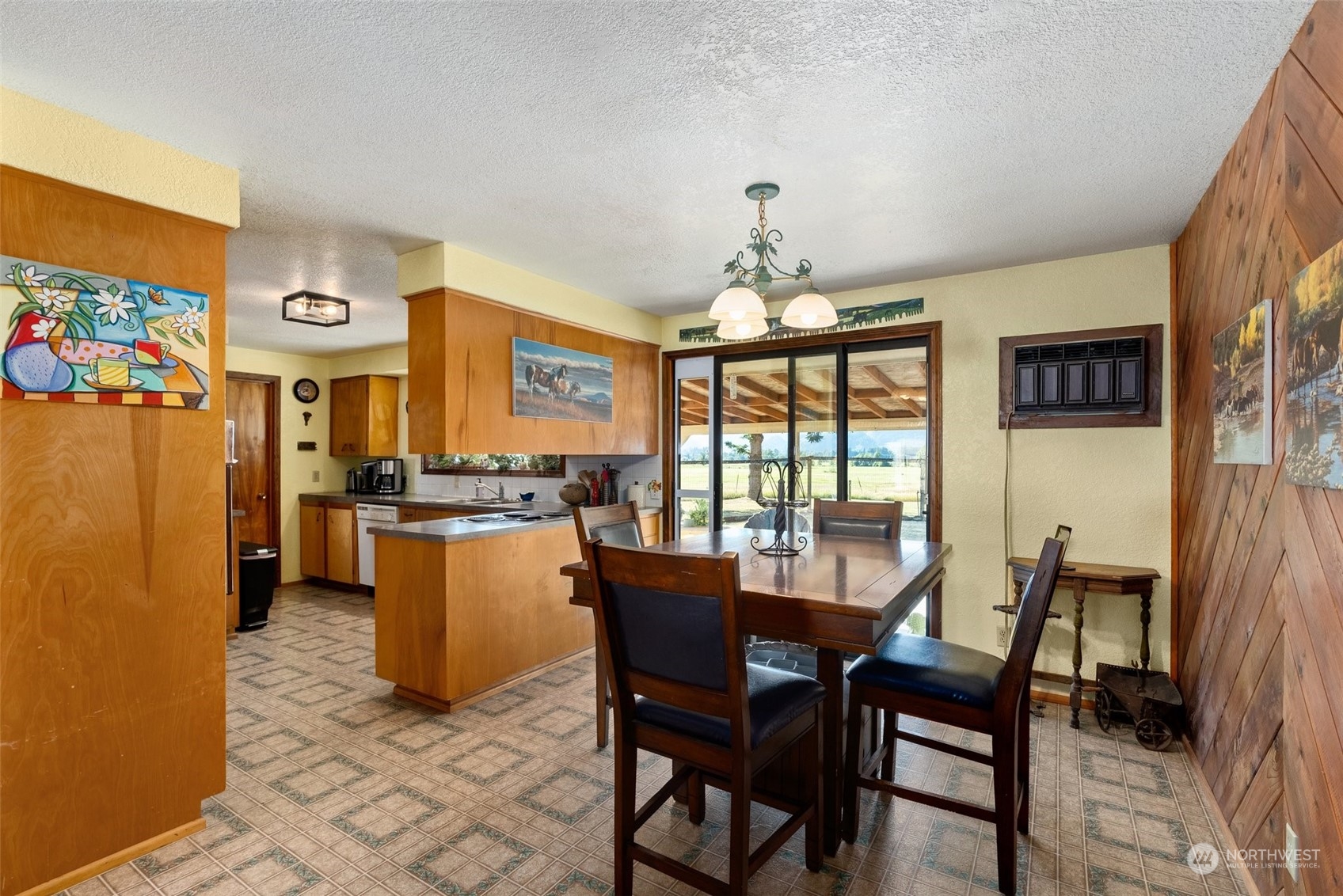 434 Cispus Road Randle, WA 98377 - Photo 7 of 40 a view of a dining room with furniture a chandelier and wooden floor