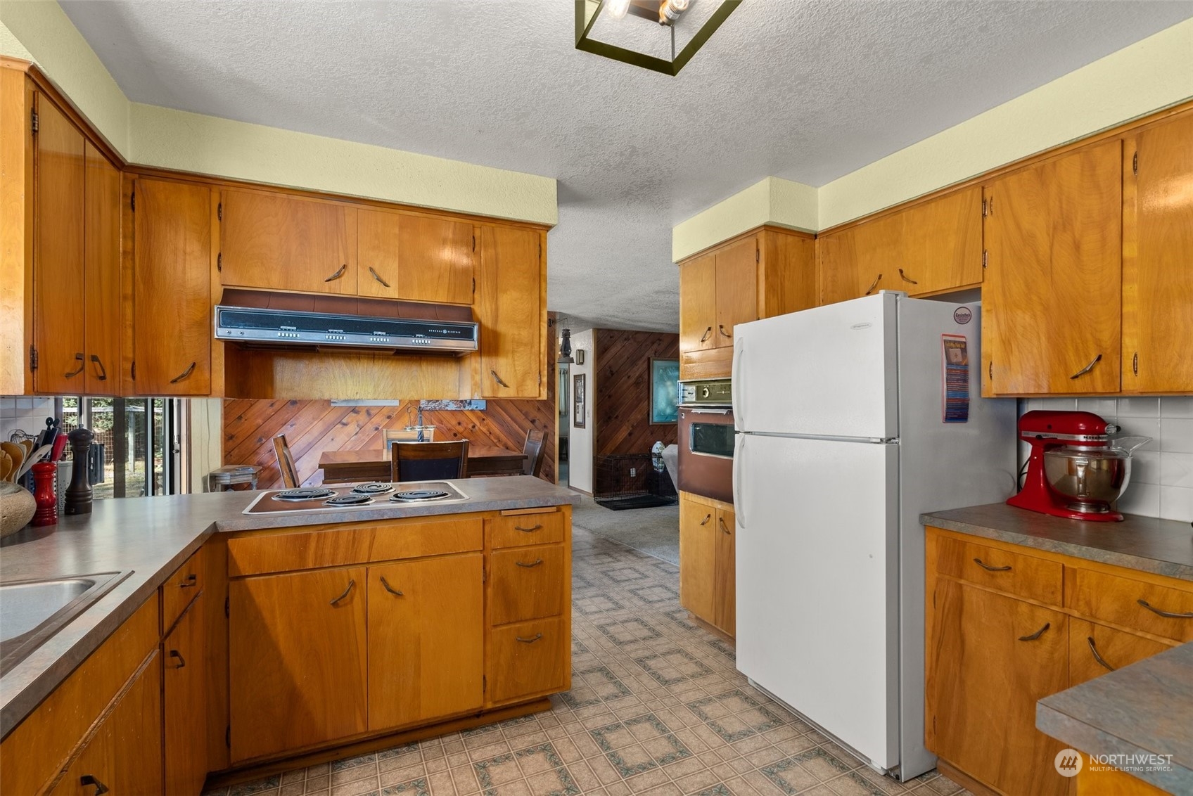 434 Cispus Road Randle, WA 98377 - Photo 10 of 40 a kitchen with refrigerator a stove a sink dishwasher and cabinets with wooden floor
