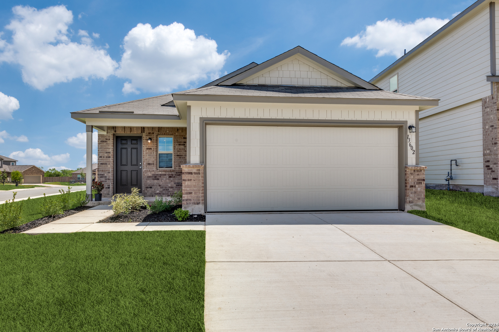 a front view of a house with garden