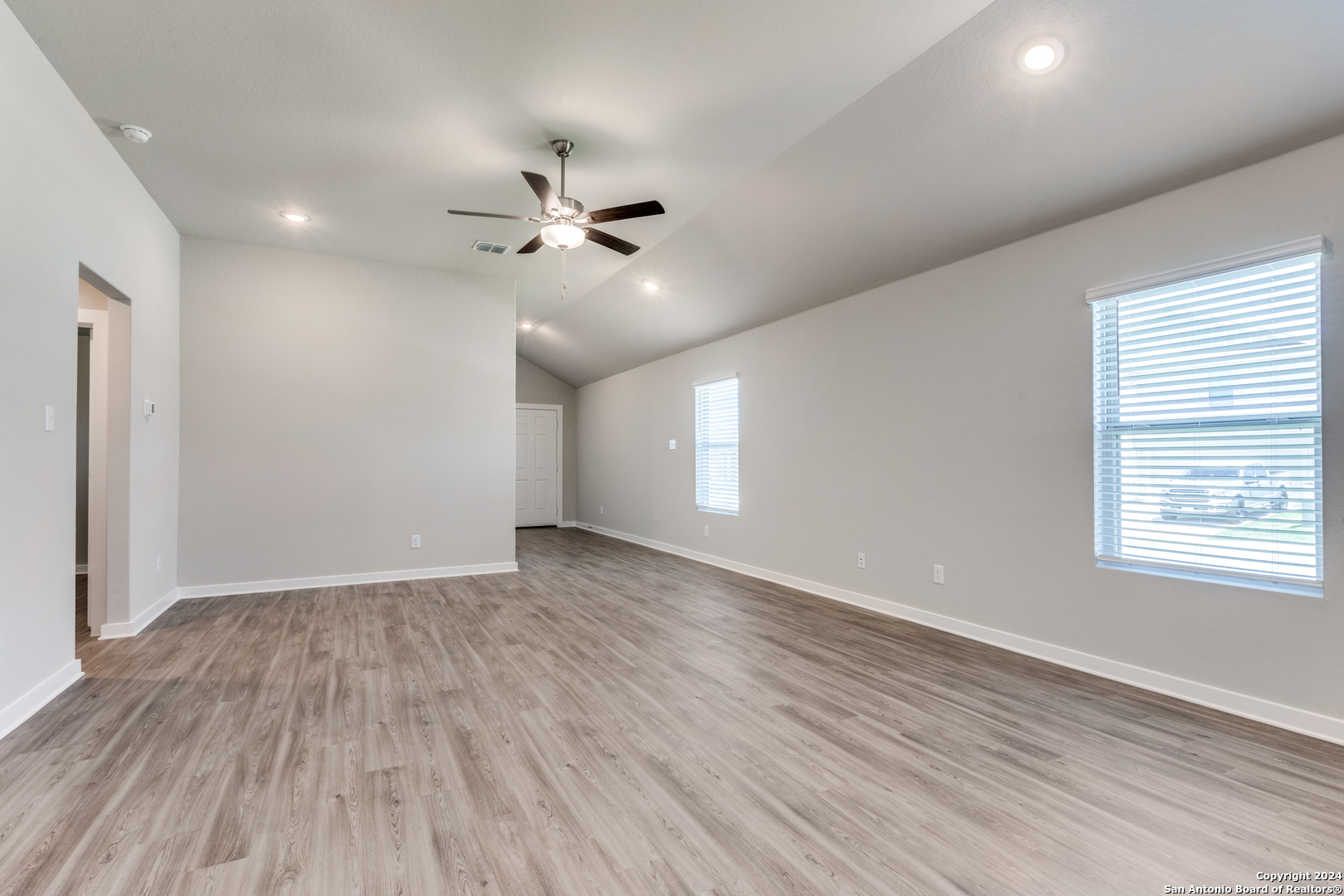 13602 Crossbow Ridge San Antonio, TX 78253 - Photo 2 of 12 a view of an empty room with a window and wooden floor