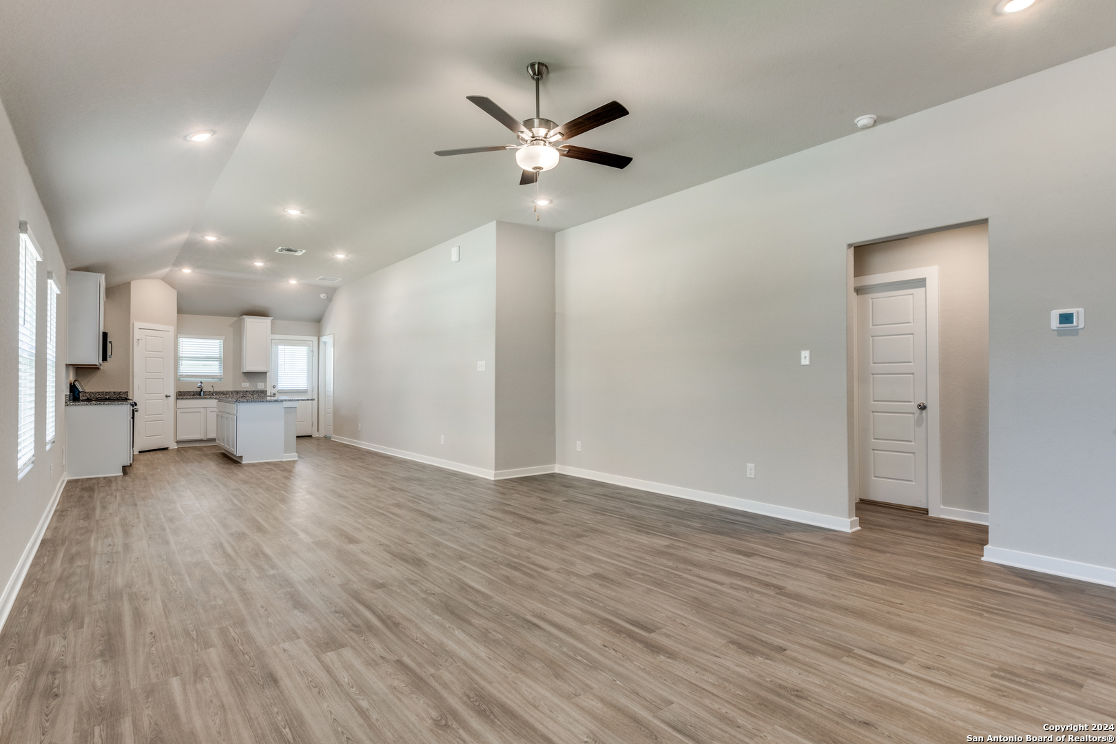 13602 Crossbow Ridge San Antonio, TX 78253 - Photo 3 of 12 a view of an empty room with wooden floor and a ceiling fan