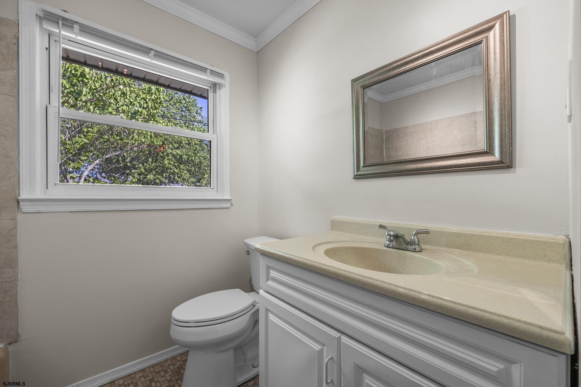 121 Osborne Road Somers Point, NJ 08244 - Photo 20 of 28 a bathroom with a toilet sink and mirror