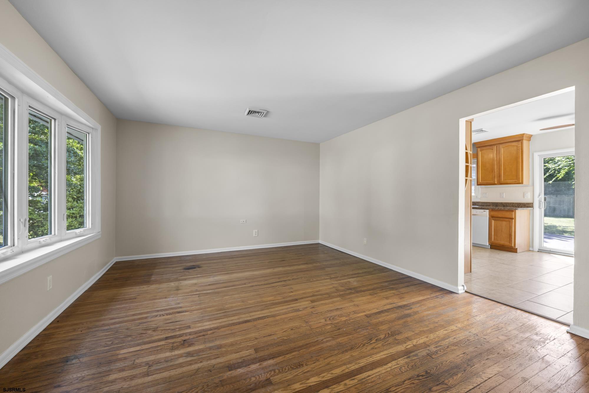 121 Osborne Road Somers Point, NJ 08244 - Photo 3 of 28 wooden floor in an empty room with a window