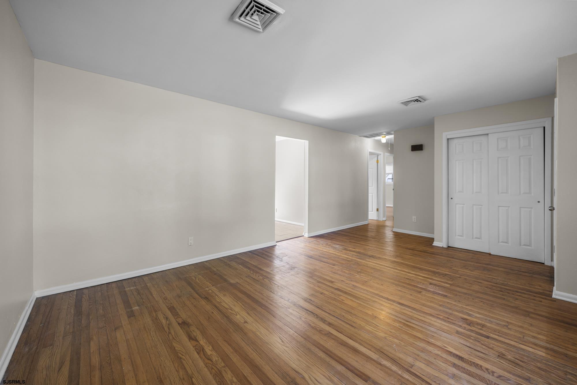 121 Osborne Road Somers Point, NJ 08244 - Photo 6 of 28 a view of an empty room with wooden floor