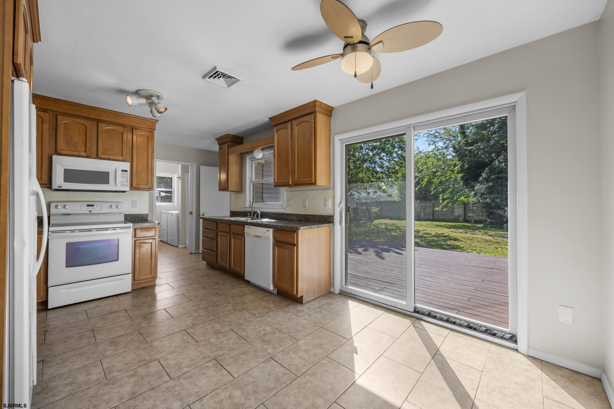 121 Osborne Road Somers Point, NJ 08244 - Photo 7 of 28 a kitchen with stainless steel appliances granite countertop a stove a sink and a refrigerator