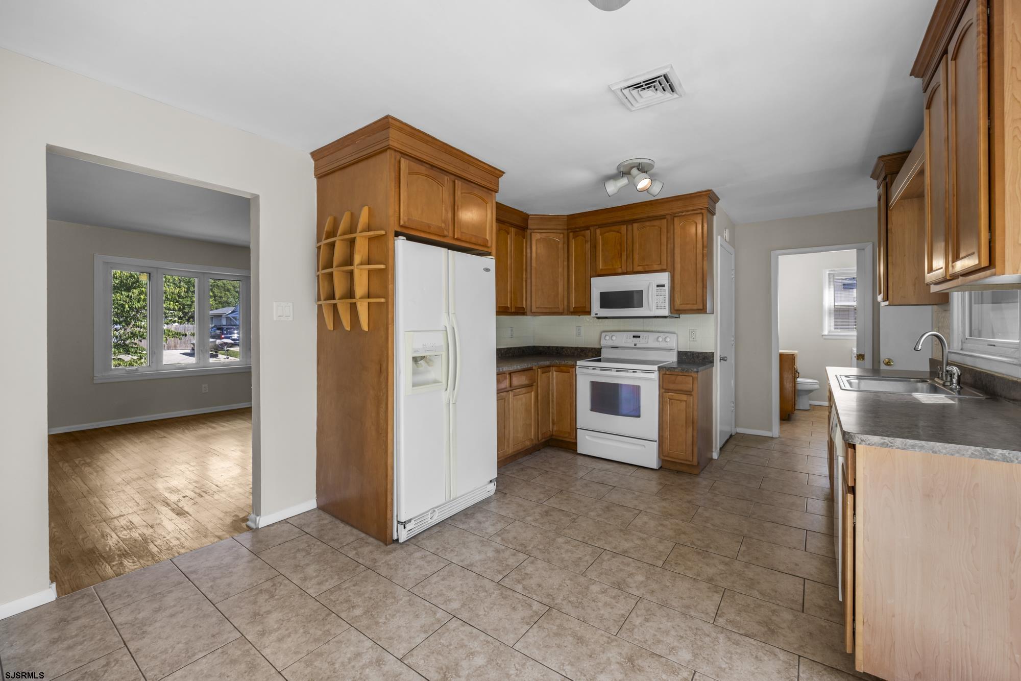 121 Osborne Road Somers Point, NJ 08244 - Photo 8 of 28 a kitchen with stainless steel appliances granite countertop a refrigerator and a stove top oven