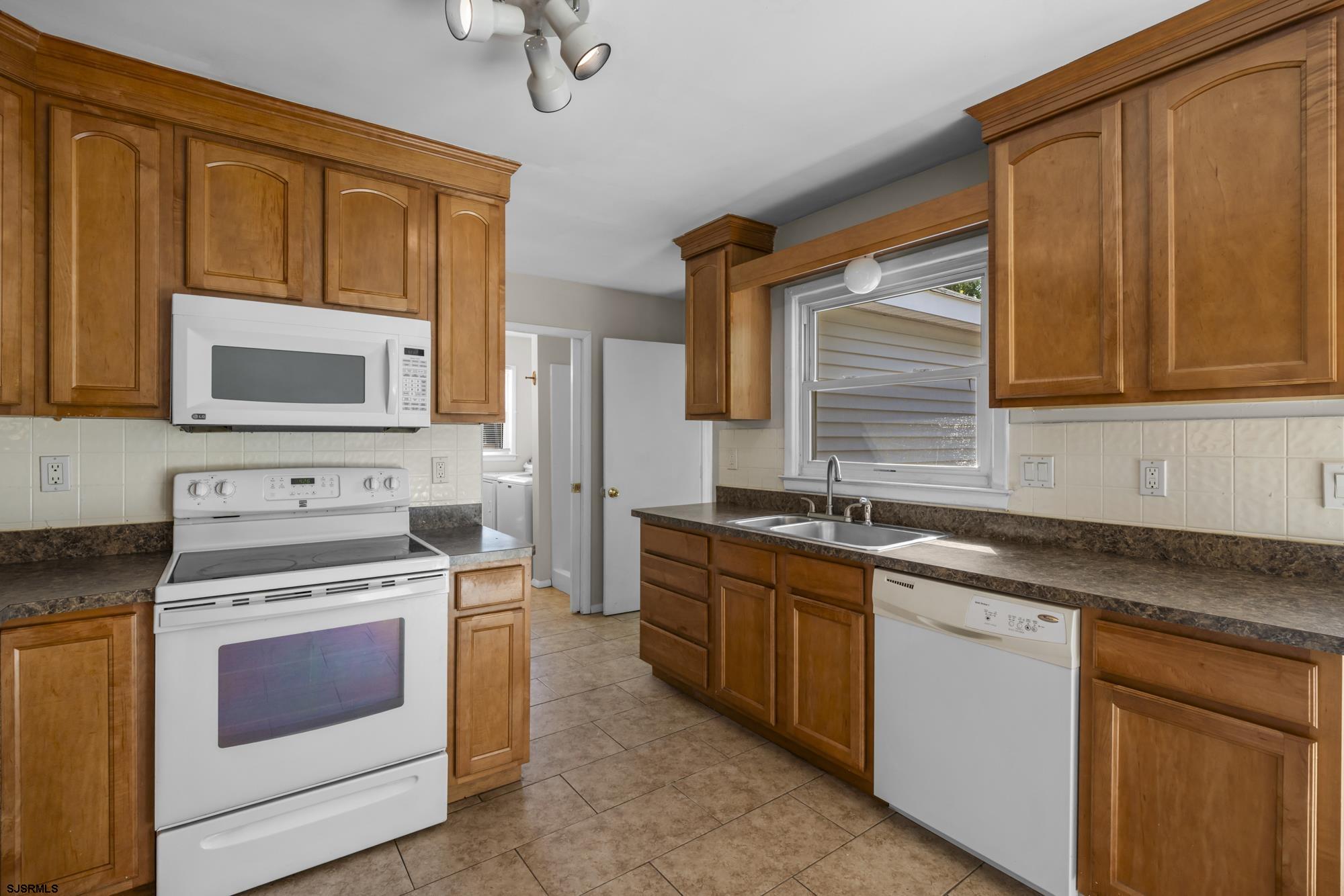 121 Osborne Road Somers Point, NJ 08244 - Photo 10 of 28 a kitchen with stainless steel appliances granite countertop a stove sink microwave and cabinets