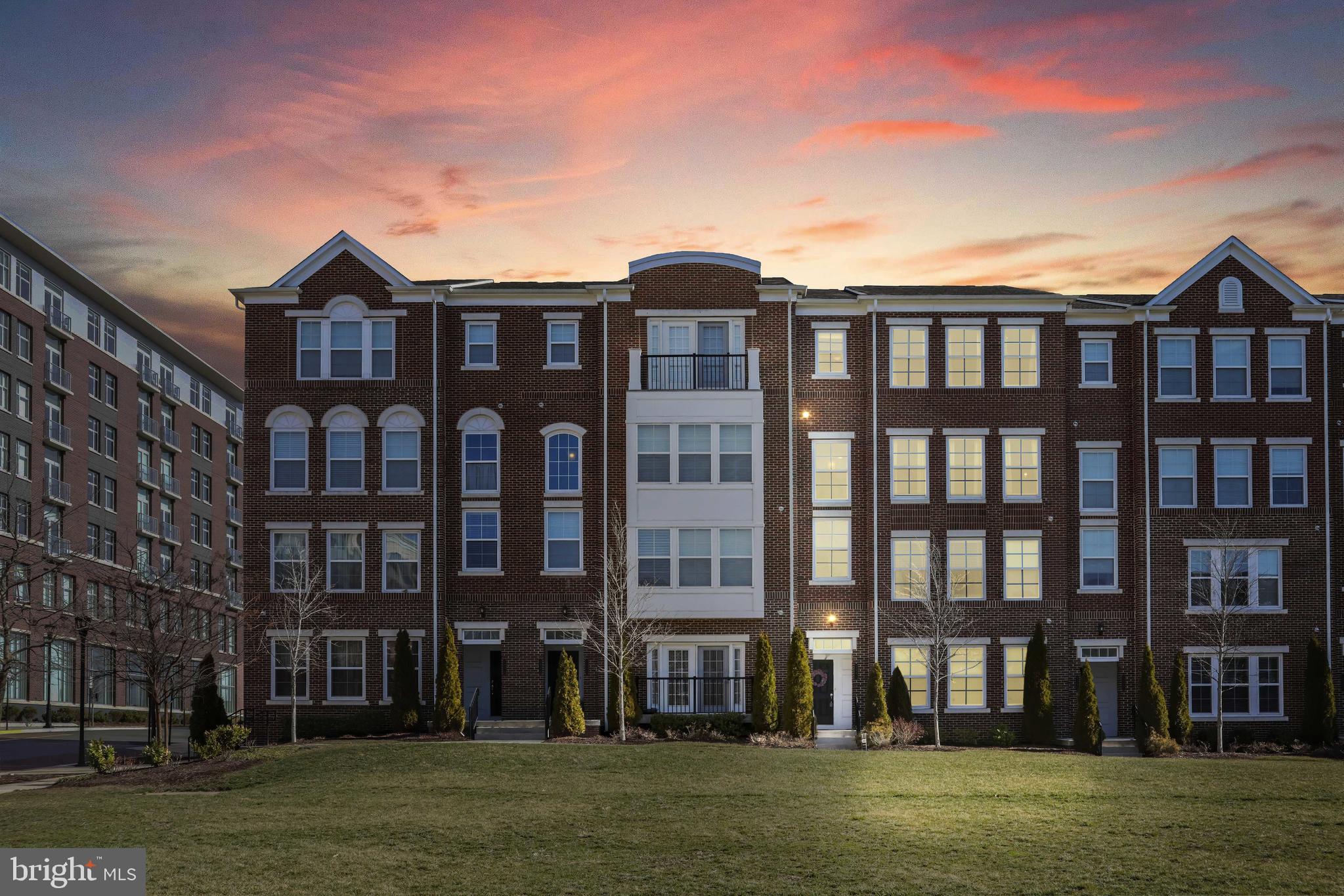 a front view of a residential apartment building with a yard