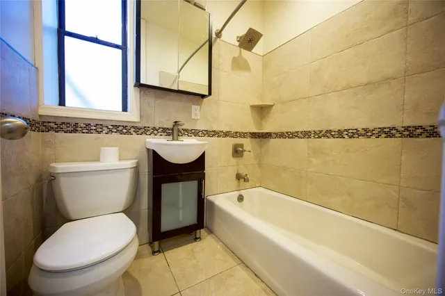 a bathroom with a toilet a sink and bathtub