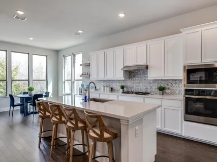 a kitchen with a table chairs stove and cabinets