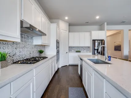 a kitchen with kitchen island granite countertop stainless steel appliances a sink stove top oven and cabinets
