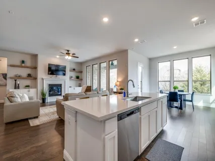 a large living room with fireplace furniture and a large window